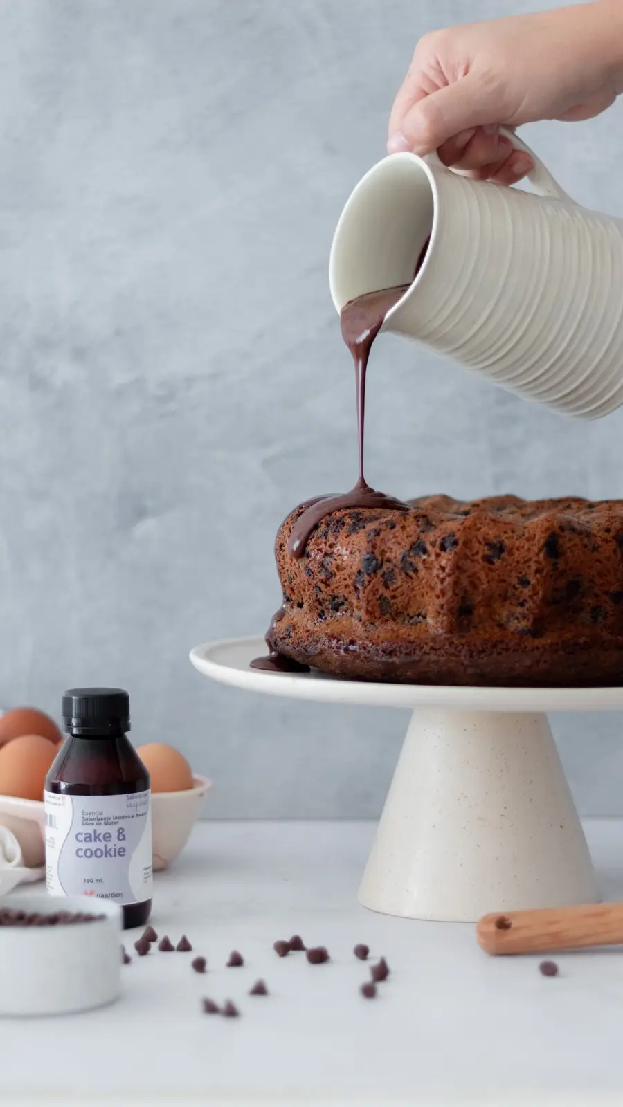 Bundt cake de chocolate con ganache cayendo desde una jarra